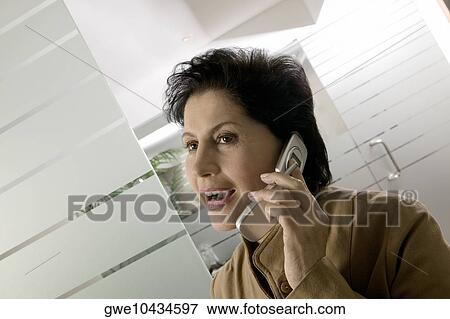 Close-up of a businesswoman using a mobile phone View Large Photo Image Stock Photo - Close-up of a businesswoman using a mobile phone. Fotosearch