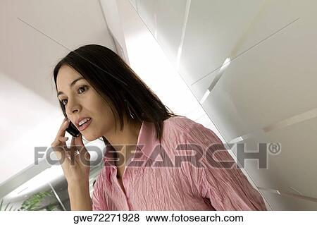 Stock Photo - Close-up of a businesswoman using a mobile phone. Fotosearch