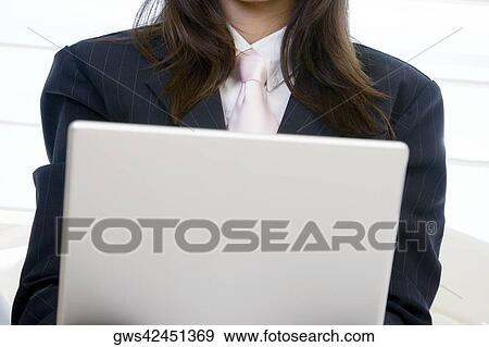 Close-up of a businesswoman using a laptop View Large Photo Image Stock Photo - Close-up of a businesswoman using a laptop. Fotosearch