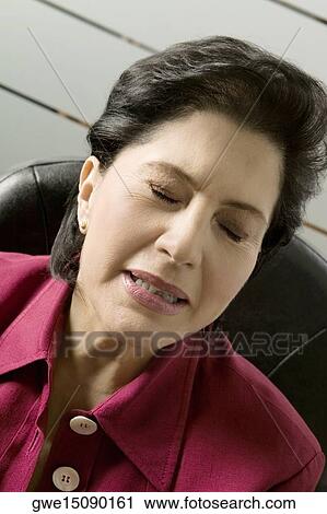 Stock Image - Close-up of a businesswoman with her eyes closed. Fotosearch
