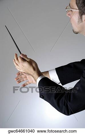 Stock Image - Close-up of a conductor holding a baton. Fotosearch