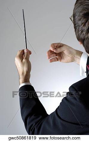 Stock Photo - Close-up of a conductor holding a baton. Fotosearch