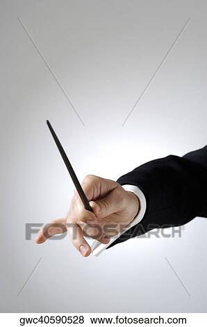 Close-up of a conductor's hand holding a baton View Large Photo Image Stock Photo - Close-up of a conductor's hand holding a baton. Fotosearch