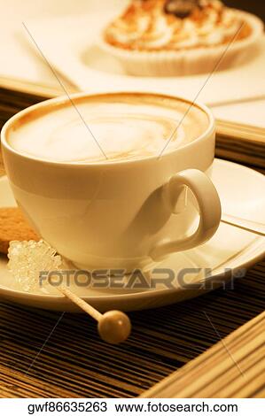 Close-up of a cup of coffee with sugar candy and a cookie View Large Photo Image Stock Image - Close-up of a cup of coffee with sugar candy and a cookie. Fotosearch
