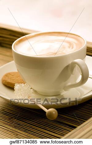 Close-up of a cup of coffee with sugar candy and a cookie View Large Photo Image Stock Photography - Close-up of a cup of coffee with sugar candy and a cookie. Fotosearch