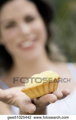 Close-up of a cupcake on a young woman's hand View Large Photo Image Stock Image - Close-up of a cupcake on a young woman's hand. Fotosearch