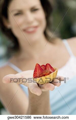 Close-up of a cupcake on a young woman's hand View Large Photo Image Stock Photograph - Close-up of a cupcake on a young woman's hand. Fotosearch