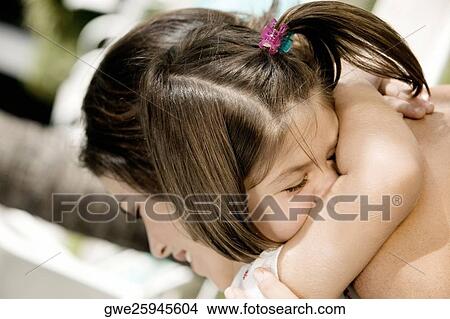Close-up of a daughter hugging her mother View Large Photo Image Picture - Close-up of a daughter hugging her mother. Fotosearch