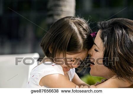Stock Photo - Close-up of a daughter hugging her mother. Fotosearch