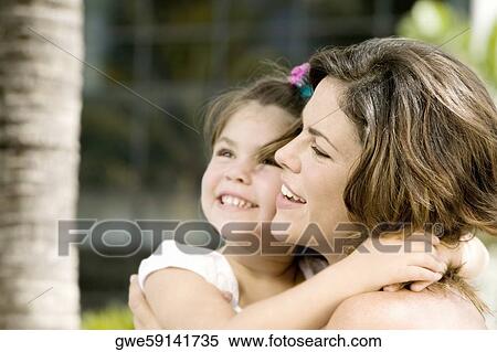 Stock Photography - Close-up of a daughter hugging her mother. Fotosearch