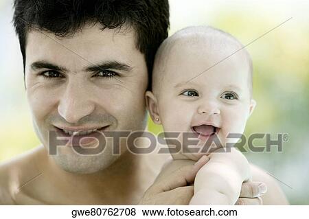 Close-up of a father with his baby girl View Large Photo Image Stock Photo - Close-up of a father with his baby girl. Fotosearch