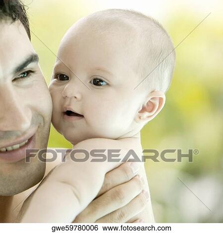 Close-up of a father with his baby girl View Large Photo Image Stock Photograph - Close-up of a father with his baby girl. Fotosearch