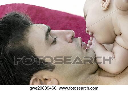 Stock Image - Close-up of a father with his daughter. Fotosearch