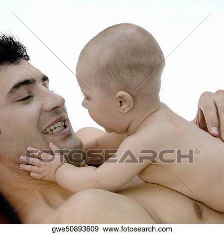 Close-up of a father with his daughter View Large Photo Image Stock Photo - Close-up of a father with his daughter. Fotosearch