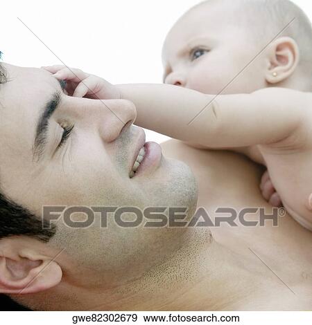 Close-up of a father with his daughter View Large Photo Image Stock Photo - Close-up of a father with his daughter. Fotosearch
