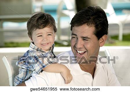 Close-up of a father with his son smiling View Large Photo Image Stock Photography - Close-up of a father with his son smiling. Fotosearch