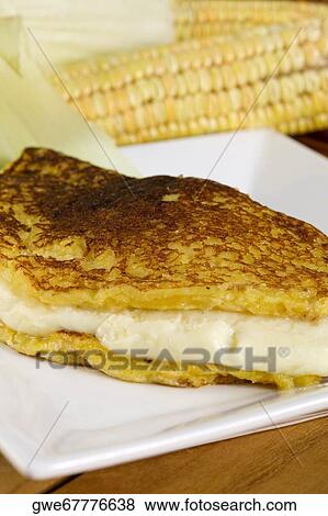 Stock Photo - Close-up of a fish fillet with corn in a plate. Fotosearch
