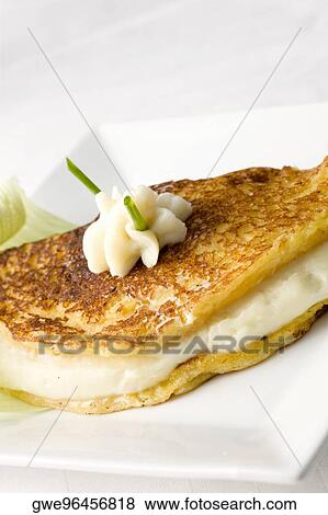 Stock Photo - Close-up of a fish fillet with whipped cream on it. Fotosearch