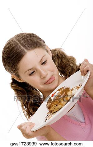 Close-up of a girl holding dessert in a plate View Large Photo Image Stock Photo - Close-up of a girl holding dessert in a plate. Fotosearch