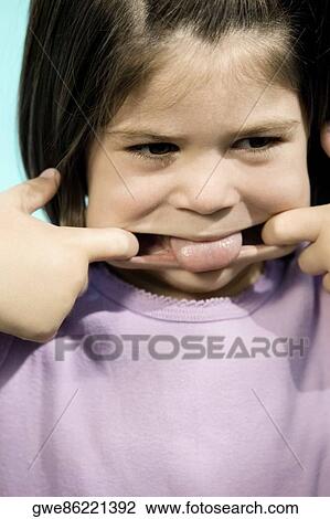 Close-up of a girl making a face View Large Photo Image Stock Image - Close-up of a girl making a face. Fotosearch