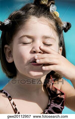 Close-up of a girl with her eyes closed View Large Photo Image Stock Photo - Close-up of a girl with her eyes closed. Fotosearch