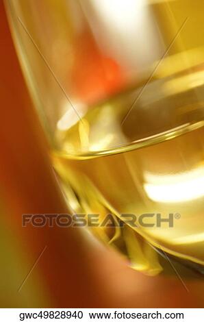 Close-up of a glass of wine with a wine bottle View Large Photo Image Stock Image - Close-up of a glass of wine with a wine bottle. Fotosearch