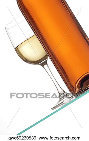 Close-up of a glass of wine with a wine bottle View Large Photo Image Stock Photo - Close-up of a glass of wine with a wine bottle. Fotosearch