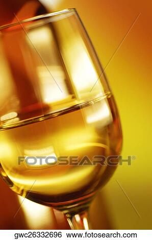 Close-up of a glass of wine with a wine bottle View Large Photo Image Stock Photograph - Close-up of a glass of wine with a wine bottle. Fotosearch