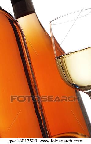 Stock Image - Close-up of a glass of wine with two wine bottles. Fotosearch