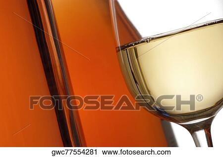 Close-up of a glass of wine with two wine bottles View Large Photo Image Stock Image - Close-up of a glass of wine with two wine bottles. Fotosearch
