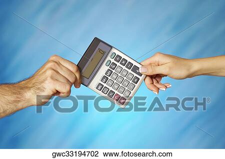 Stock Image - Close-up of a man and a woman's hands holding a calculator. Fotosearch