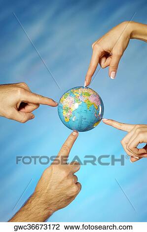 Close-up of a man and a woman's hands pointing to a globe View Large Photo Image Stock Image - Close-up of a man and a woman's hands pointing to a globe. Fotosearch