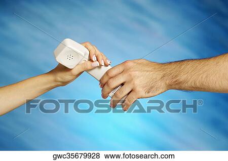 Close-up of a man and a woman's hands holding a telephone receiver View Large Photo Image Stock Photo - Close-up of a man and a woman's hands holding a telephone receiver. Fotosearch