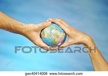 Stock Photo - Close-up of a man and a woman's hands holding a globe. Fotosearch
