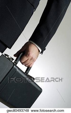 Close-up of a man holding a case View Large Photo Image Stock Photo - Close-up of a man holding a case. Fotosearch