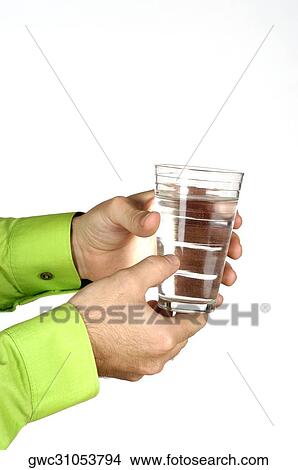 Close-up of a man holding a glass of water View Large Photo Image Picture - Close-up of a man holding a glass of water. Fotosearch