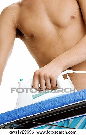 Stock Photography - Close-up of a man ironing. Fotosearch