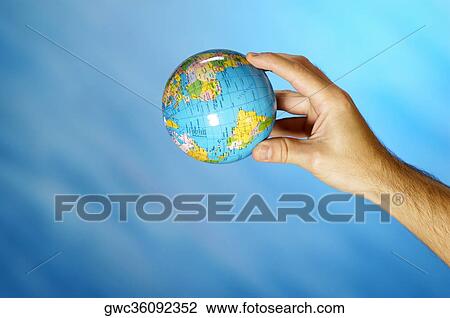 Close-up of a man's hand holding a globe View Large Photo Image Stock Image - Close-up of a man's hand holding a globe. Fotosearch