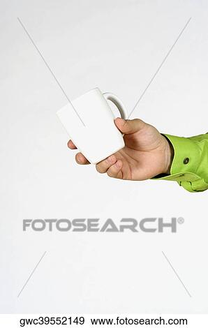 Stock Photo - Close-up of a man's hand holding a mug. Fotosearch