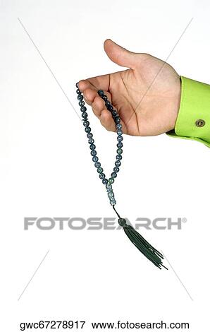 Close-up of a man's hand holding prayer beads View Large Photo Image Stock Photo - Close-up of a man's hand holding prayer beads. Fotosearch