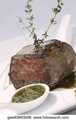 Close-up of a meat loaf with a spoon full of gravy in a plate View Large Photo Image Stock Photo - Close-up of a meat loaf with a spoon full of gravy in a plate. Fotosearch