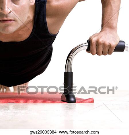 Close-up of a mid adult man doing push-ups View Large Photo Image Picture - Close-up of a mid adult man doing push-ups. Fotosearch