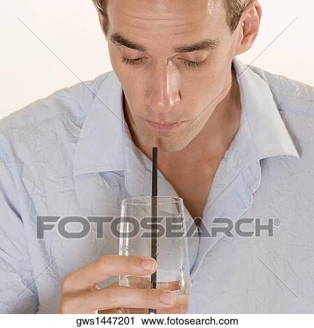 Close-up of a mid adult man drinking with a straw View Large Photo Image Stock Image - Close-up of a mid adult man drinking with a straw. Fotosearch