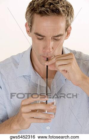 Close-up of a mid adult man drinking with a straw View Large Photo Image Stock Photograph - Close-up of a mid adult man drinking with a straw. Fotosearch