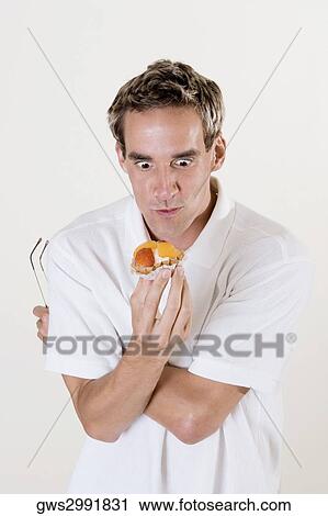 Close-up of a mid adult man looking at a fruit tart View Large Photo Image Stock Image - Close-up of a mid adult man looking at a fruit tart. Fotosearch