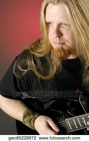 Close-up of a mid adult man playing the electric guitar View Large Photo Image Stock Image - Close-up of a mid adult man playing the electric guitar. Fotosearch