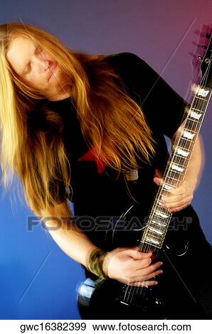 Close-up of a mid adult man playing the electric guitar View Large Photo Image Stock Photo - Close-up of a mid adult man playing the electric guitar. Fotosearch