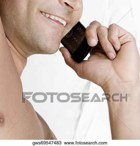 Close-up of a mid adult man talking on a mobile phone View Large Photo Image Stock Image - Close-up of a mid adult man talking on a mobile phone. Fotosearch