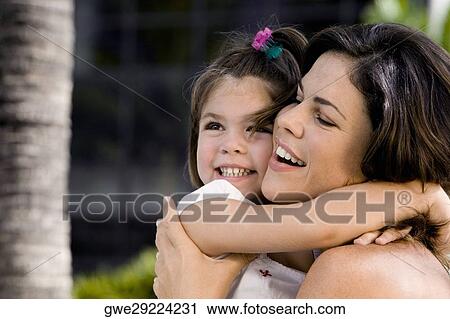 Close-up of a mother hugging her daughter View Large Photo Image Stock Image - Close-up of a mother hugging her daughter. Fotosearch