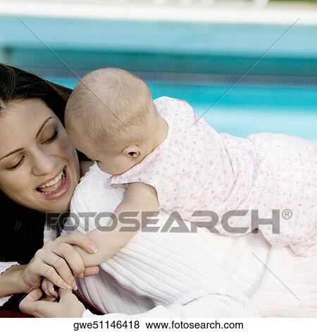 Close-up of a mother with her daughter playing View Large Photo Image Stock Photo - Close-up of a mother with her daughter playing. Fotosearch